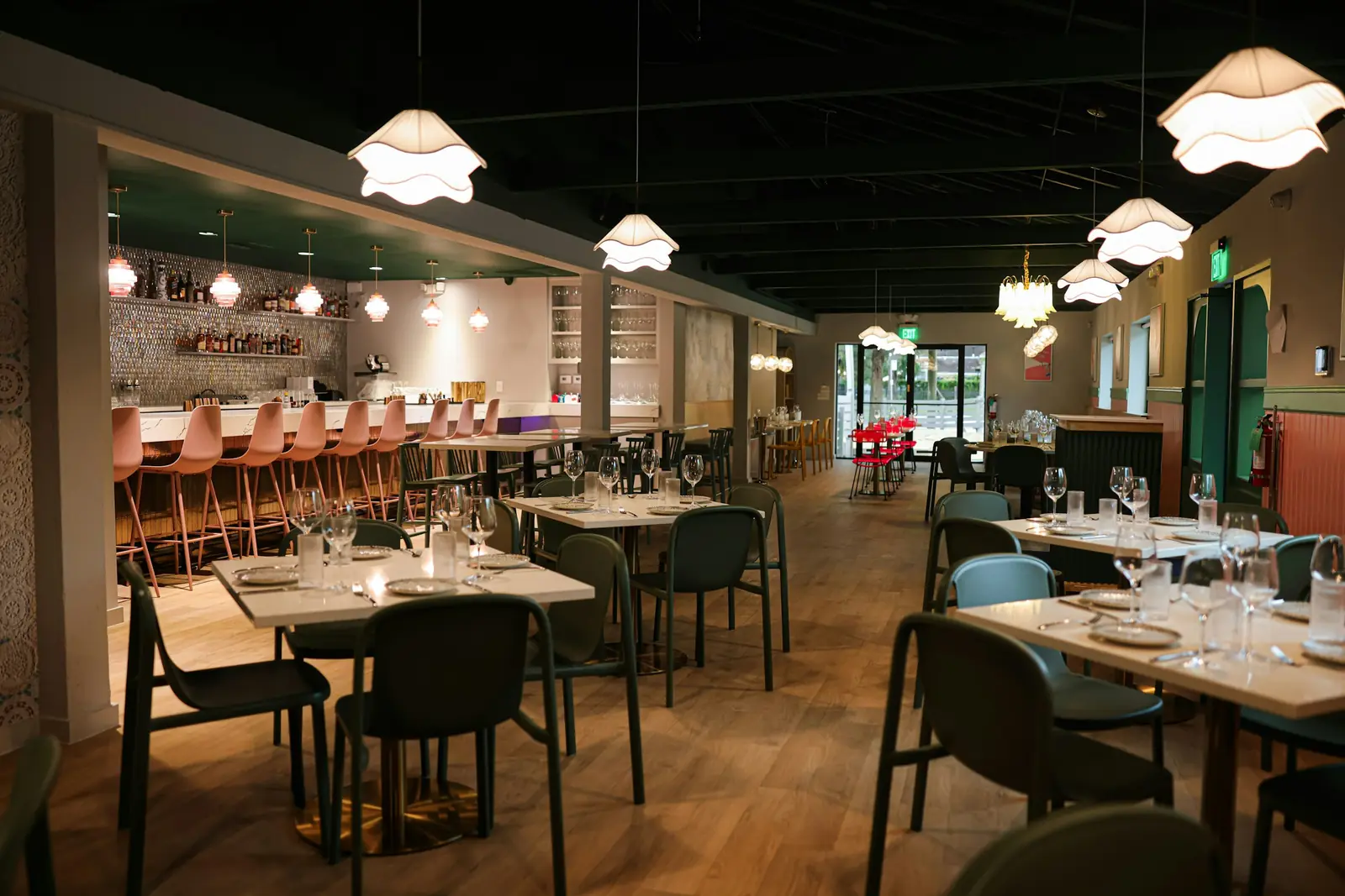 An empty neighbourhood restaurant before service, tables set