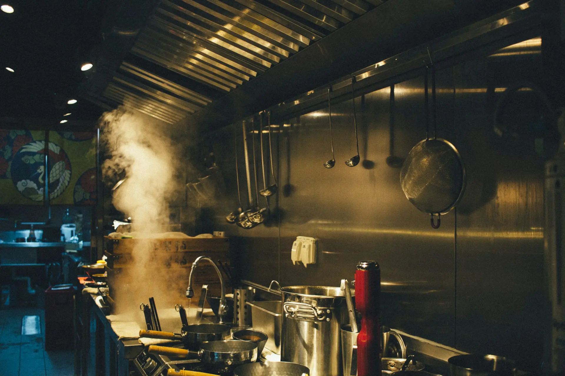 A restaurant cook line, steam rising from the stock pots